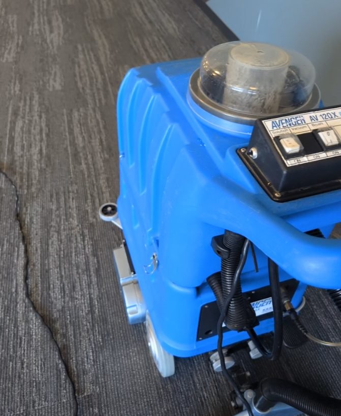 Hot water extraction machine cleaning commercial office carpet in Winnipeg